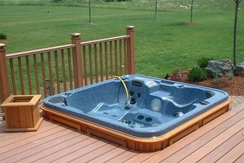 arctic spas hot tub in deck corner